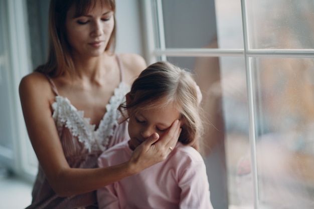 Madre e hija pequeña niña en casa.