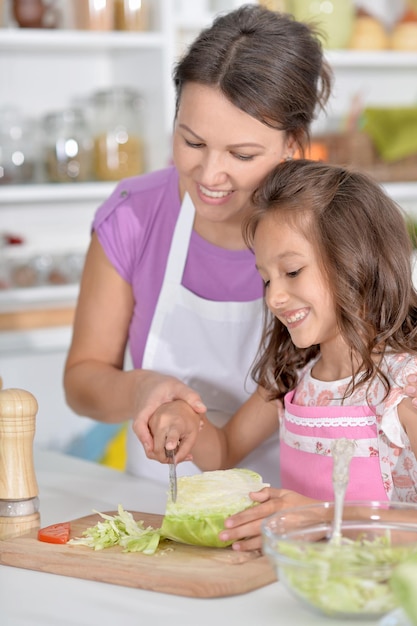 Madre e hija preparando la cena juntas en la cocina