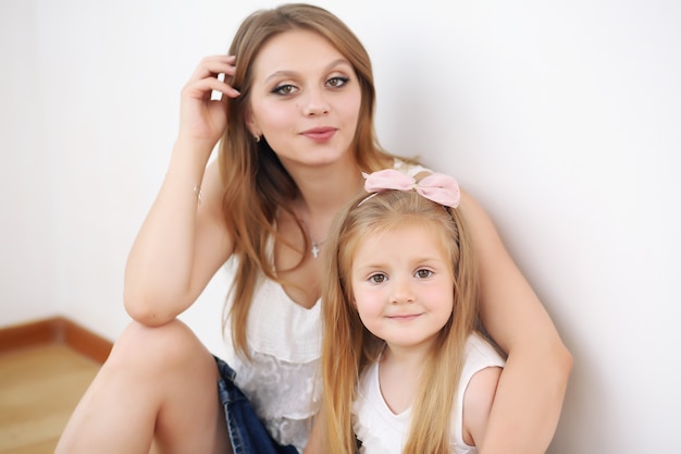 Madre e hija sentadas en el suelo