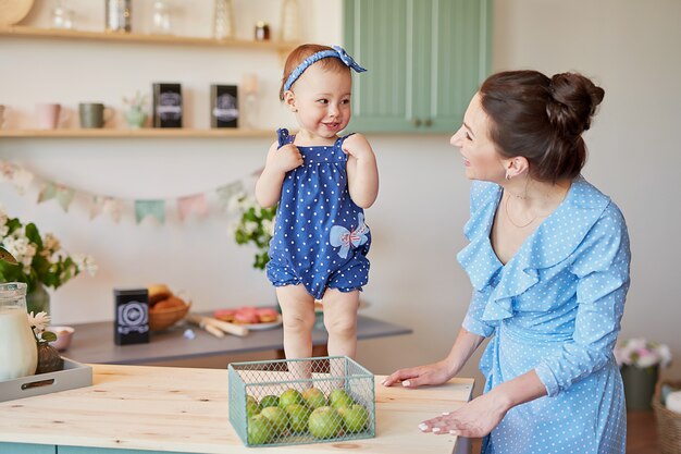 Madre de familia y su hija en la mañana desayunan en la cocina.