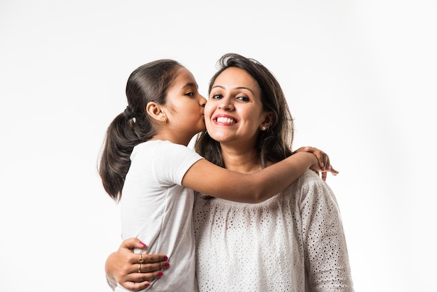 Madre hija india sobre fondo blanco abrazar, besar, montar, volar, señalar, presentar sobre fondo blanco.