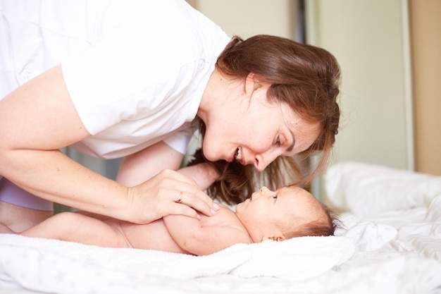 Madre juega con su bebé recién nacido Retrato casero realista