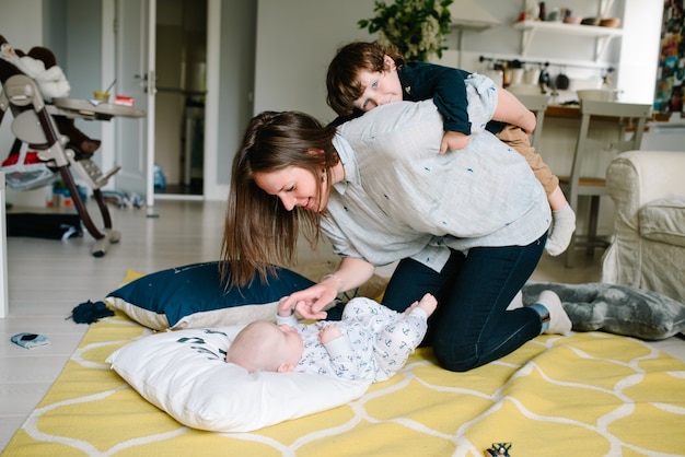 Madre jugando con su hijo en el suelo en casa