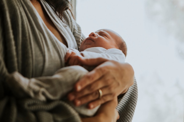 Madre sosteniendo a su bebé dentro