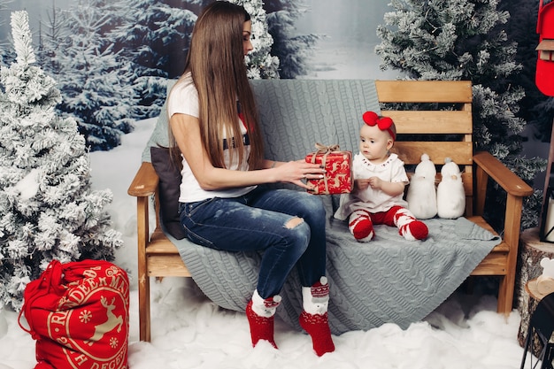 Mãe amorosa, decorar a árvore de natal com bebê