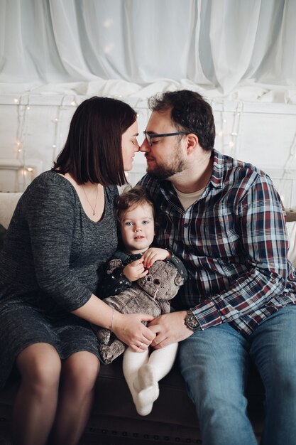 Foto mãe atraente, pai e seu lindo filhinho em casa