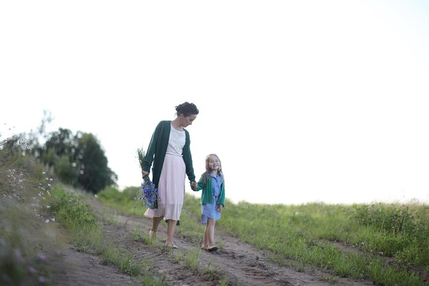 Mãe com filha andando na estrada