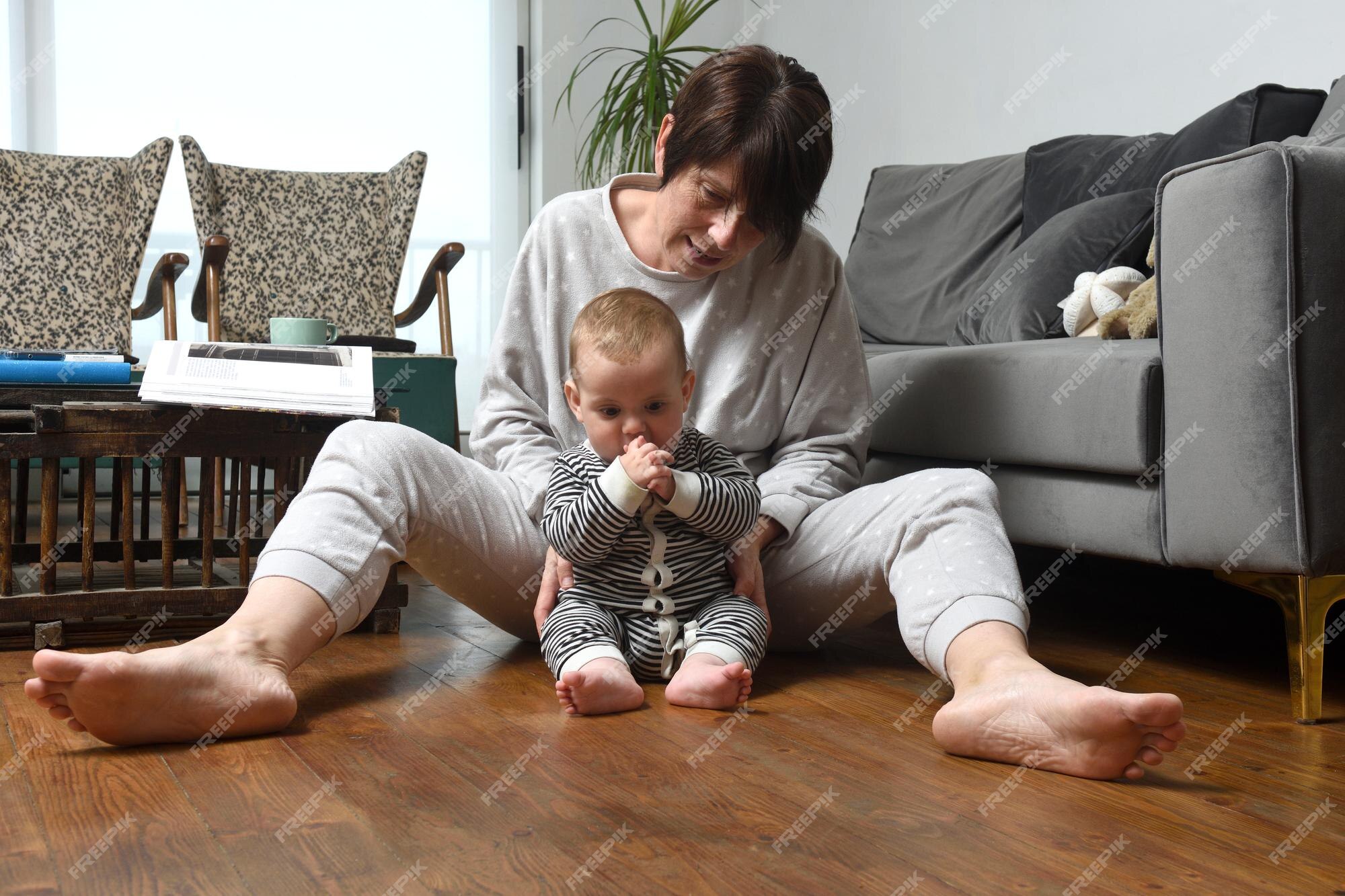 Mãe Ajuda Um Bebê Recém Nascido a Sentar. Criança Gritando Na Sala De Jogos  Em Um Chão De Espuma Mole Foto de Stock - Imagem de gritar, casa: 215291796