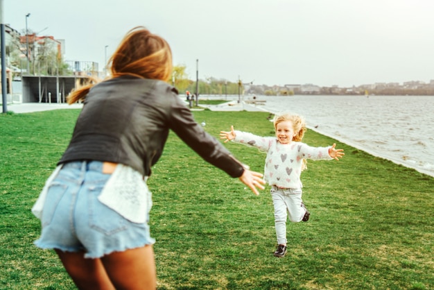 Mãe com sua filhinha se divertir no parque