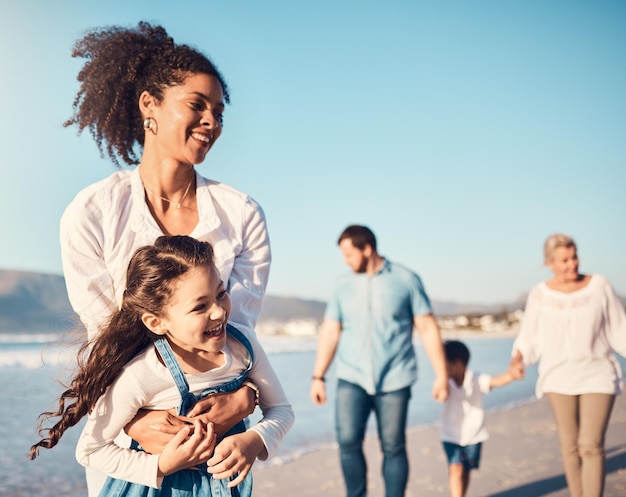 Mãe criança e brincando ao ar livre na praia em um feriado de férias em família ou aventura no verão Menina animada e uma mulher com energia divertida, felicidade e amor ou tempo de qualidade no mar