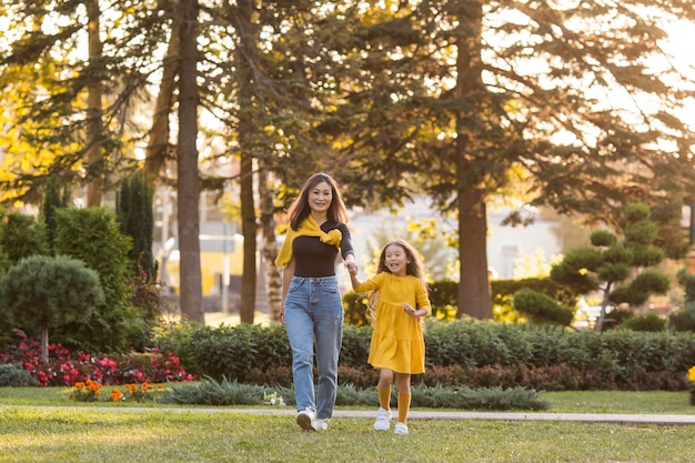 Foto mãe e filha asiática passeando no parque