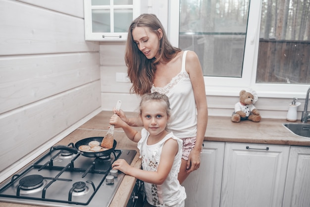 Mãe e filha cozinhando juntas na cozinha
