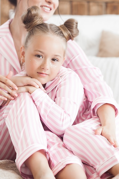 Mãe e filha dormindo de pijama