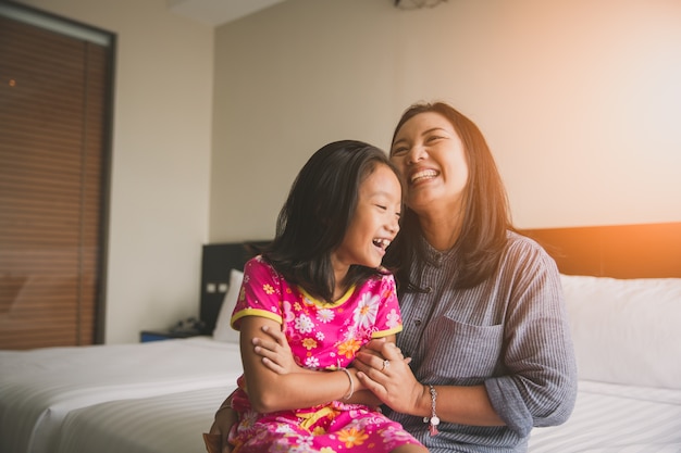 Mãe e filha gostam de brincar na cama