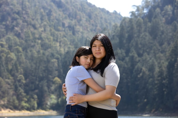 Mãe e filha mexicanas abraçando o dia das mulheres ao ar livre