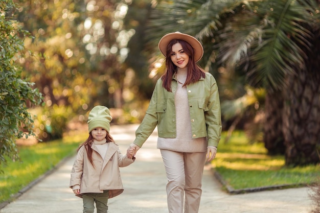 Mãe e filha ruivas estão andando no parque de lazer familiar na cidade