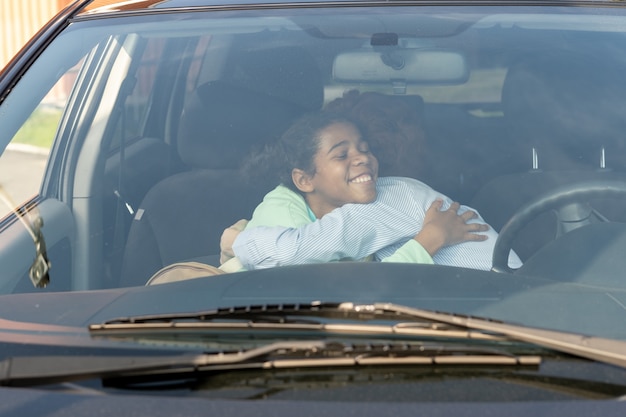 Mãe e filha se dando um abraço de despedida antes de irem para a escola