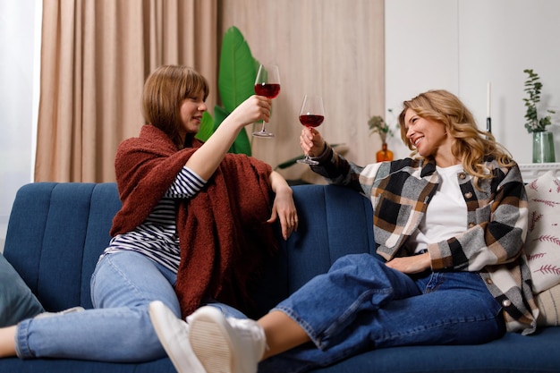 Mãe e filha se divertindo tinindo copos de vinho