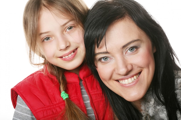 Mãe e filha sorrindo para a câmera