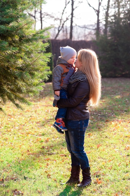 Mãe e filho brincando no parque de outono