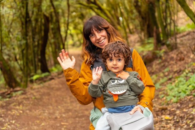 Mãe e filho se divertindo caminhando na trilha na floresta de árvores musgosas do Parque Nacional Garajonay La Gomera Ilhas Canárias