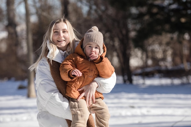 Mãe e filhos felizes caminhando no parque Família feliz brincando ao ar livre no tempo frio Pessoas de maternidade familiar e conceito de férias