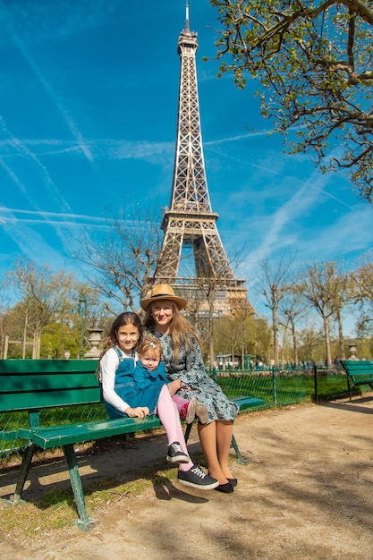 Mãe e filhos perto da torre eiffel foco seletivo