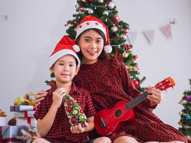 Mãe estava tocando violão no dia de Natal com menino