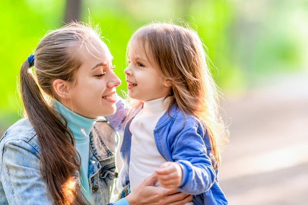 Mãe feliz com sua filha em uma caminhada na floresta Dia de verão bom humor