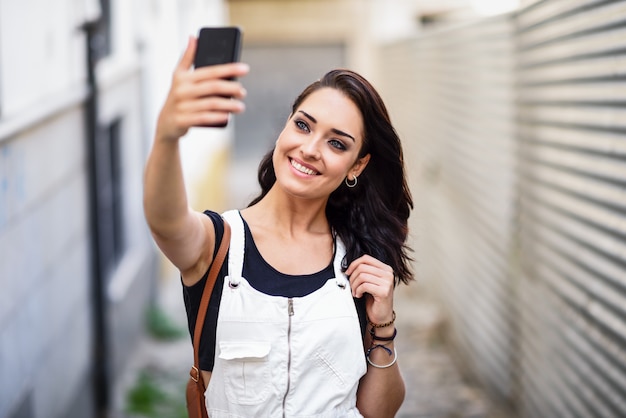 Mädchen, das draußen selfie Foto mit intelligentem Telefon macht