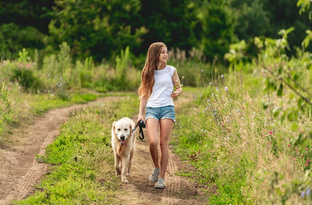 Mädchen, das mit Hund auf Natur läuft