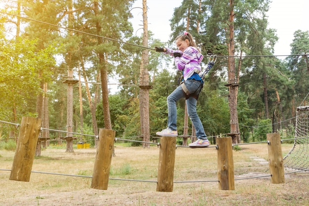 Mädchen im abenteuer, das hochseilpark klettert