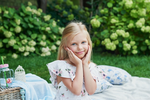 Mädchen im Garten bei einem Picknick im Sommer