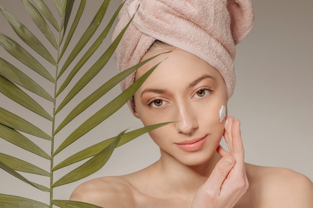 Mädchen mit Handtuch auf dem Kopf mit Blatt