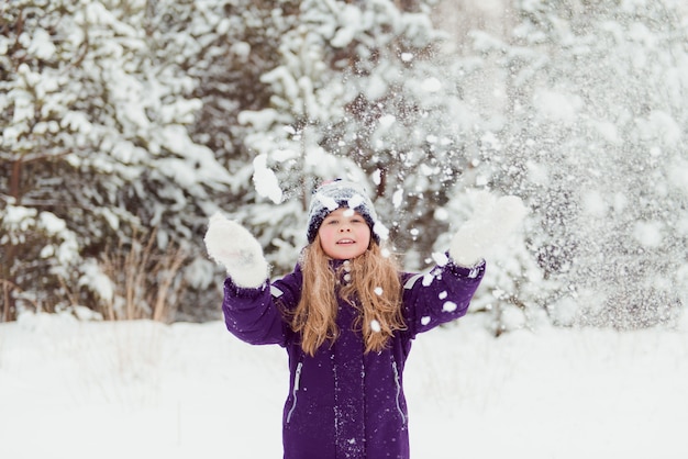 Mädchen spielen mit Schnee Winterspaß im Freien Schneebälle werfen