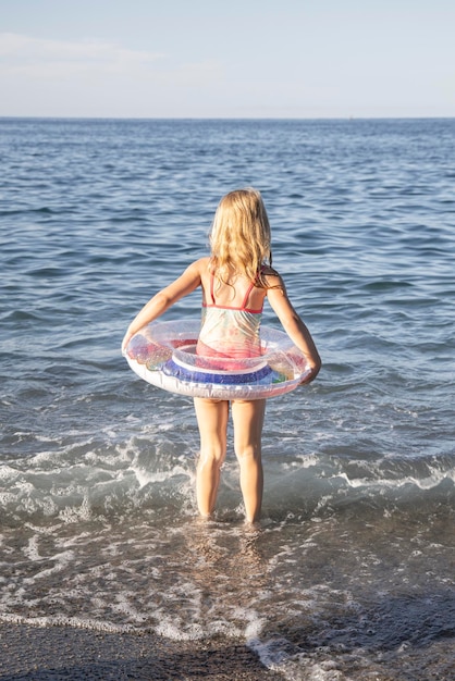 Foto mädchen steht am meer und am strand