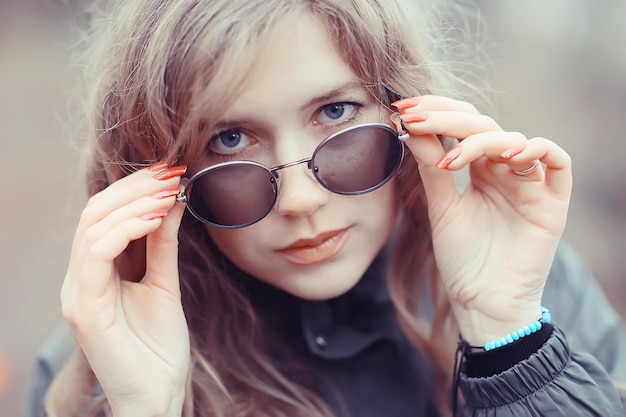 Mädchenbrille Herbstporträt, ein glamouröser Herbstlook einer erwachsenen Frau