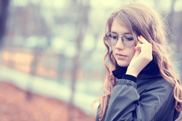 Mädchenbrille Herbstporträt, ein glamouröser Herbstlook einer erwachsenen Frau