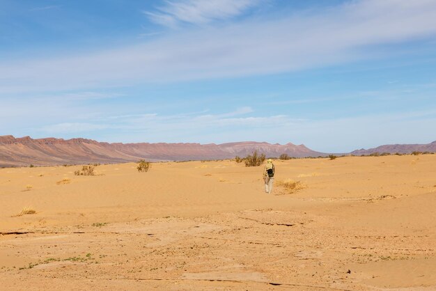 Männliche Touristen, die auf den Sanddünen der Sahara-Wüste Marokkos gehen