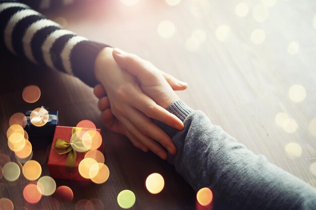 Männliche weibliche Hände halten Geschenkbox zum Geburtstag auf Holzhintergrund Vatertag Valentinstag Weihnachten Neujahr Herzlichen Glückwunsch Hintergrund