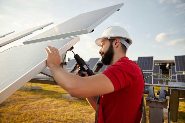 Männlicher Techniker, der Solarpanel installiert