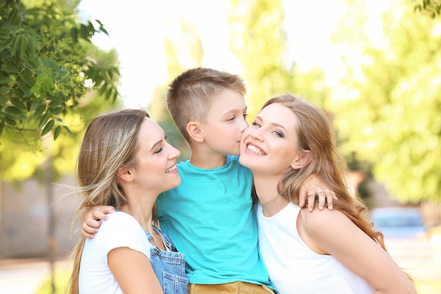 Mães lésbicas e filho adotivo se divertindo ao ar livre