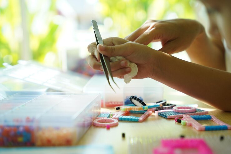 Foto la maestra en el taller enseñó a dos chicas cómo montar un termo mosaico.
