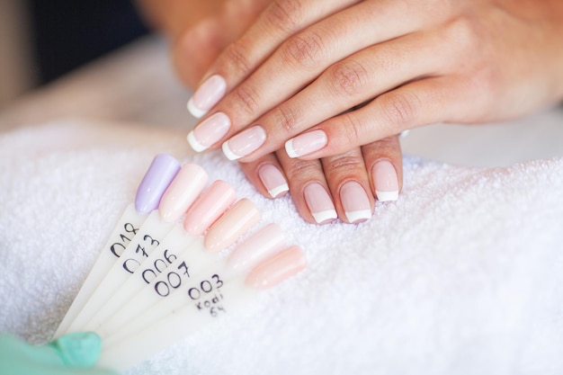 Maestro de uñas haciendo manicura en estudio de belleza