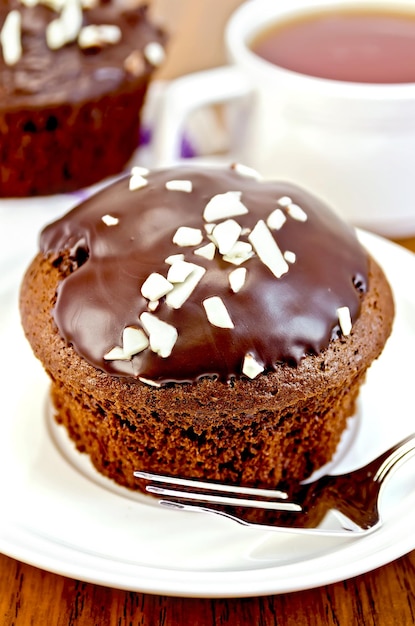 Magdalena de chocolate en un plato blanco con un tenedor