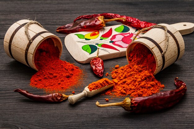 Magyar (húngaro) pimentón rojo dulce y caliente en polvo. Patrón tradicional en una tabla de cortar, diferentes variedades de pimiento seco.