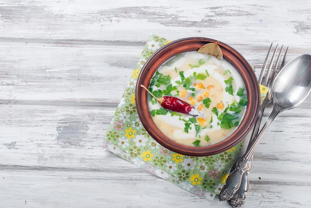 Maissuppe in einer keramischen Platte und in den Bestandteilen