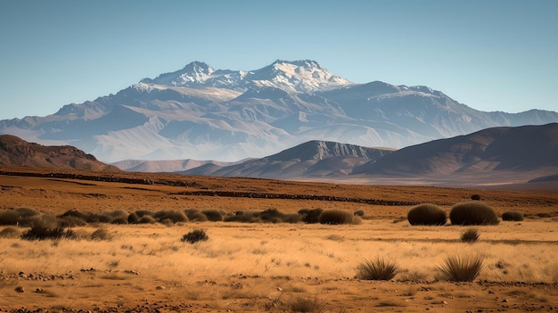 Majestica cordillera que se eleva sobre vastas llanuras áridas paisaje natural pacífico bajo cielos despejados perfecto para viajes y temas de naturaleza IA