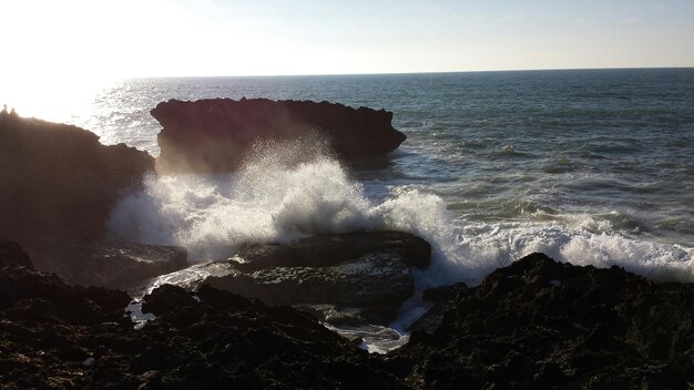 Foto las majestuosas olas se estrellan contra la costa rocosa.