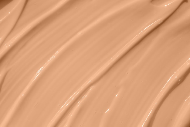 Make-up-Basis Creme strukturierter Hintergrund Beige Nude Liquid Foundation Textur Concealer Abstrich Verschmieren